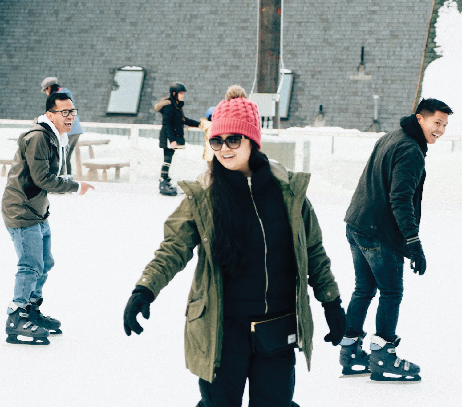 Three smiling ice skaters