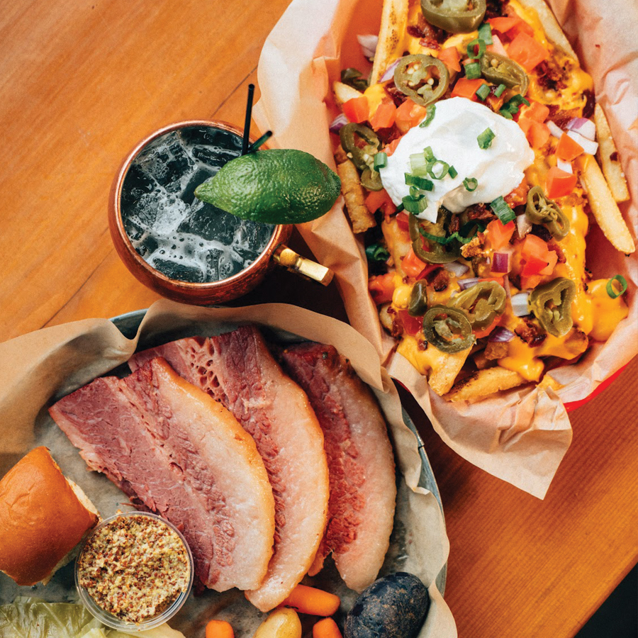 Shamrocks and Shenanigans food specials: Corned beef, Irish nachos, and a cold drink with a lime wedge.