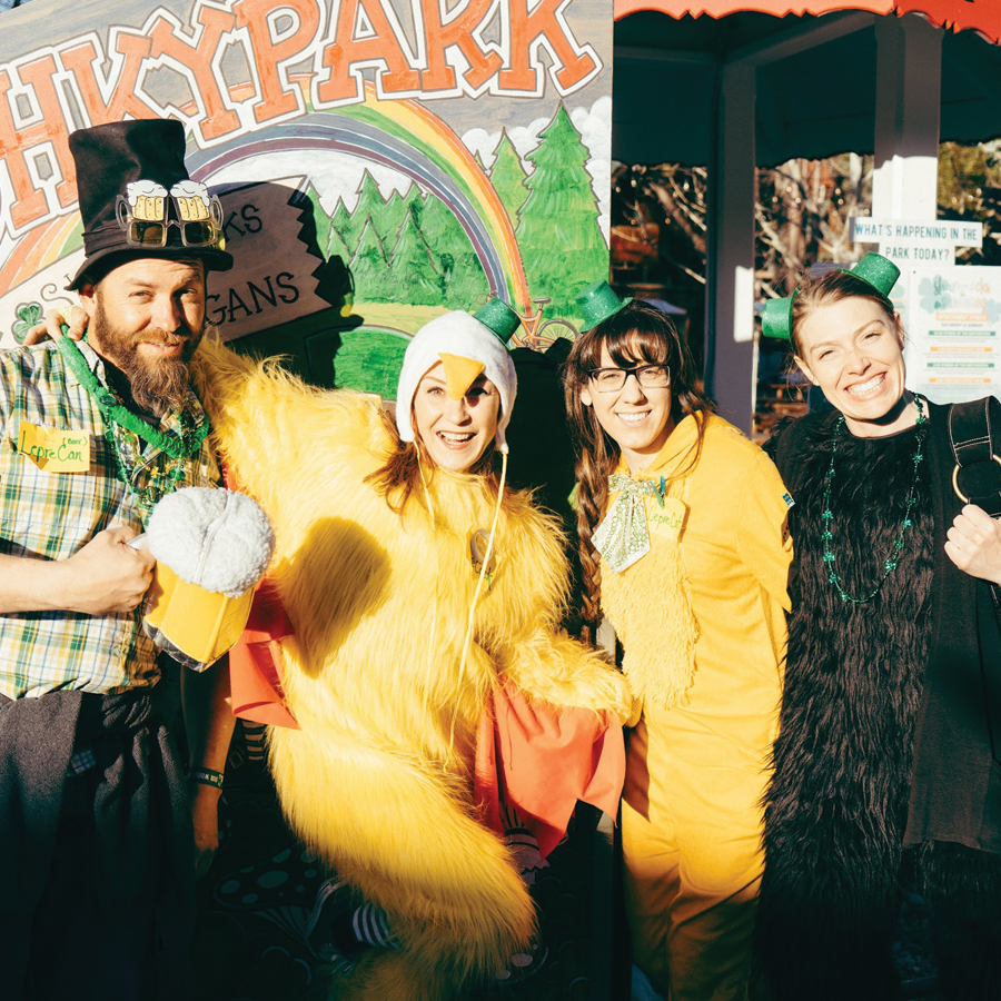 Four adults dressed in festive attire for Shamrocks and Shenanigans.
